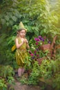 Portrait of a cute cute girl in a green gnome hat with a flower Royalty Free Stock Photo