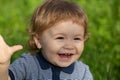 Portrait of cute excited boy having fun in garden. Baby face close up. Funny little child closeup portrait. Blonde kid Royalty Free Stock Photo