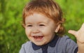 Portrait of cute excited boy having fun in garden. Baby face close up. Funny little child closeup portrait. Blonde kid Royalty Free Stock Photo