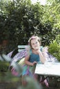 Portrait Of Cute Fairy Girl At Garden Table Royalty Free Stock Photo