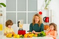 Portrait of cute family is making fruit juice. on white kitchen. Royalty Free Stock Photo