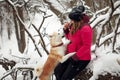 Portrait with a cute fluffy puppy. Winter walk with a dog. Royalty Free Stock Photo