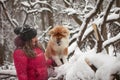 Portrait with a cute fluffy puppy. Winter walk with a dog. Royalty Free Stock Photo