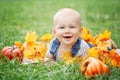 Portrait of cute funny adorable blond Caucasian baby boy with blue eyes in tshirt and jeans romper lying on grass field meadow Royalty Free Stock Photo