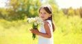 Cute girl child with wildflowers in sunny summer park Royalty Free Stock Photo