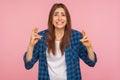 Portrait of cute girl crossing fingers showing gesture for good luck fortune, looking with imploring eyes