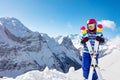 Portrait of cute girl in pink helmet and color ski Royalty Free Stock Photo