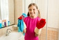 Portrait of cute girl in rubber gloves doing cleanup at bathroom Royalty Free Stock Photo