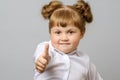 Portrait of cute girl showing thumbs up sign Royalty Free Stock Photo