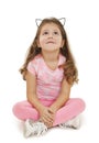 Portrait of a cute girl sitting on the floor, looking up Royalty Free Stock Photo