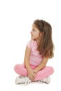 Portrait of a cute girl sitting on the floor, looking up Royalty Free Stock Photo
