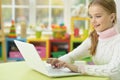 Portrait of girl using laptop while sitting Royalty Free Stock Photo