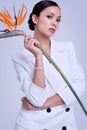 Gorgeous latin women in fashion white suit with exotic flower