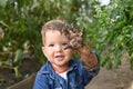 Portrait of cute happy boy showing his muddy hand