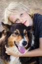 Portrait of a cute happy child hugging his pet dog Royalty Free Stock Photo