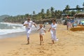 Portrait of cute happy family running on sandy beach Royalty Free Stock Photo