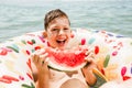 Cute happy little boy having fun in rubber ring eating juicy watermelon Royalty Free Stock Photo