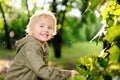 Portrait of cute happy little boy having fun in summer park after rain Royalty Free Stock Photo