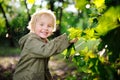 Portrait of cute happy little boy having fun in summer park after rain Royalty Free Stock Photo