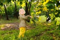 Portrait of cute happy little boy having fun in summer park after rain Royalty Free Stock Photo