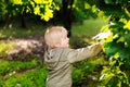 Portrait of cute happy little boy having fun in summer park after rain Royalty Free Stock Photo