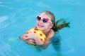 Portrait of cute happy little girl having fun in swimming pool.  Kids sport on family summer vacation. Active healthy holiday Royalty Free Stock Photo