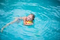 Portrait of cute happy little girl having fun in swimming pool. Kids sport on family summer vacation. Active healthy holiday Royalty Free Stock Photo