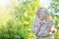 Portrait of cute happy senior couple resting in spring park Royalty Free Stock Photo