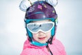 Portrait of cute happy skier girl in helmet and goggles in a winter ski resort Royalty Free Stock Photo