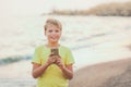 Portrait of cute happy smiling white kid using modern smart phone Royalty Free Stock Photo