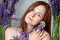 Portrait of a cute happy woman holding flowers. Looking at camera. Close up picture. Skin care concept.  Beautiful woman with Royalty Free Stock Photo