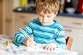 Portrait of cute healthy happy school kid boy at home making homework. Little child writing with colorful pencils Royalty Free Stock Photo