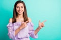 Portrait of cute impressed girl pointing empty space wear purple shirt isolated on blue color background Royalty Free Stock Photo