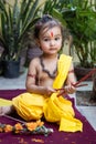 Portrait of cute Indian boy dresses as lord rama with bow at outdoor with blurred background at day