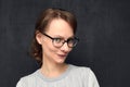 Portrait of cute and intrigued young woman with glasses
