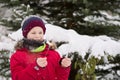 Portrait of cute kid boy looking at sparkler at the Christmas tree outdoors. Child having fun in the winter park. Lifestyle and Royalty Free Stock Photo