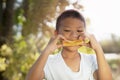 Portrait of cute kid in imagines some yummy food with eyes.