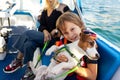 Portrait of cute liitle boy child enjoy petting cute adorable little jack russel dog puppy sailing family luxury yacht Royalty Free Stock Photo