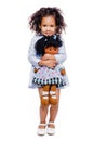 Portrait of a cute little african american girl hugging doll, isolated on white background Royalty Free Stock Photo