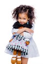 Portrait of a cute little african american girl hugging doll, isolated on white background Royalty Free Stock Photo