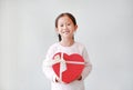 Portrait of cute little Asian child girl holding red heart gift box isolated on white background Royalty Free Stock Photo