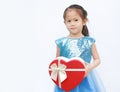 Portrait of a cute little Asian child girl with red heart gift box for Valentine festival isolated on white background Royalty Free Stock Photo