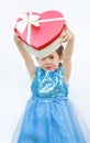 Portrait of a cute little Asian child girl with red heart gift box for Valentine festival isolated on white background Royalty Free Stock Photo