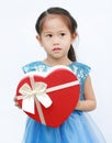 Portrait of a cute little Asian child girl with red heart gift box for Valentine festival isolated on white background Royalty Free Stock Photo