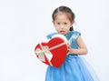 Portrait of a cute little Asian child girl with red heart gift box for Valentine festival isolated on white background Royalty Free Stock Photo