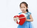 Portrait of a cute little Asian child girl with red heart gift box for Valentine festival isolated on white background Royalty Free Stock Photo