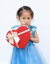 Portrait of a cute little Asian child girl with red heart gift box for Valentine festival isolated on white background Royalty Free Stock Photo
