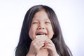 Portrait a Cute Little Asian Girl Eating Wafer on Isolate White
