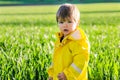 Portrait of cute little baby boy in yellow raincoat