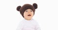 Portrait of cute little baby in brown hat with bear ears over white background Royalty Free Stock Photo